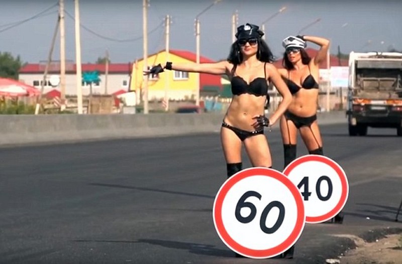 Topless Women Carry Speed Limit Signs For Road Safety Campaign in Russia 